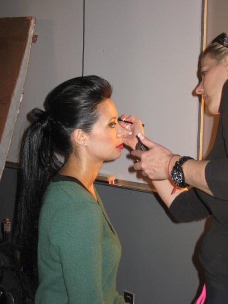 a makeup artist doing the makeup of a woman
