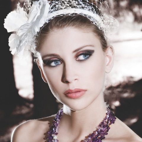 Close up of a woman with makeup and jewelry